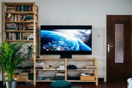 Photo of television and bookshelf and door by Jonas Leupe on Unsplash