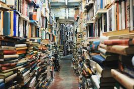 Photo of crowded bookshelves with a central aisle by Glen Noble on Unsplash